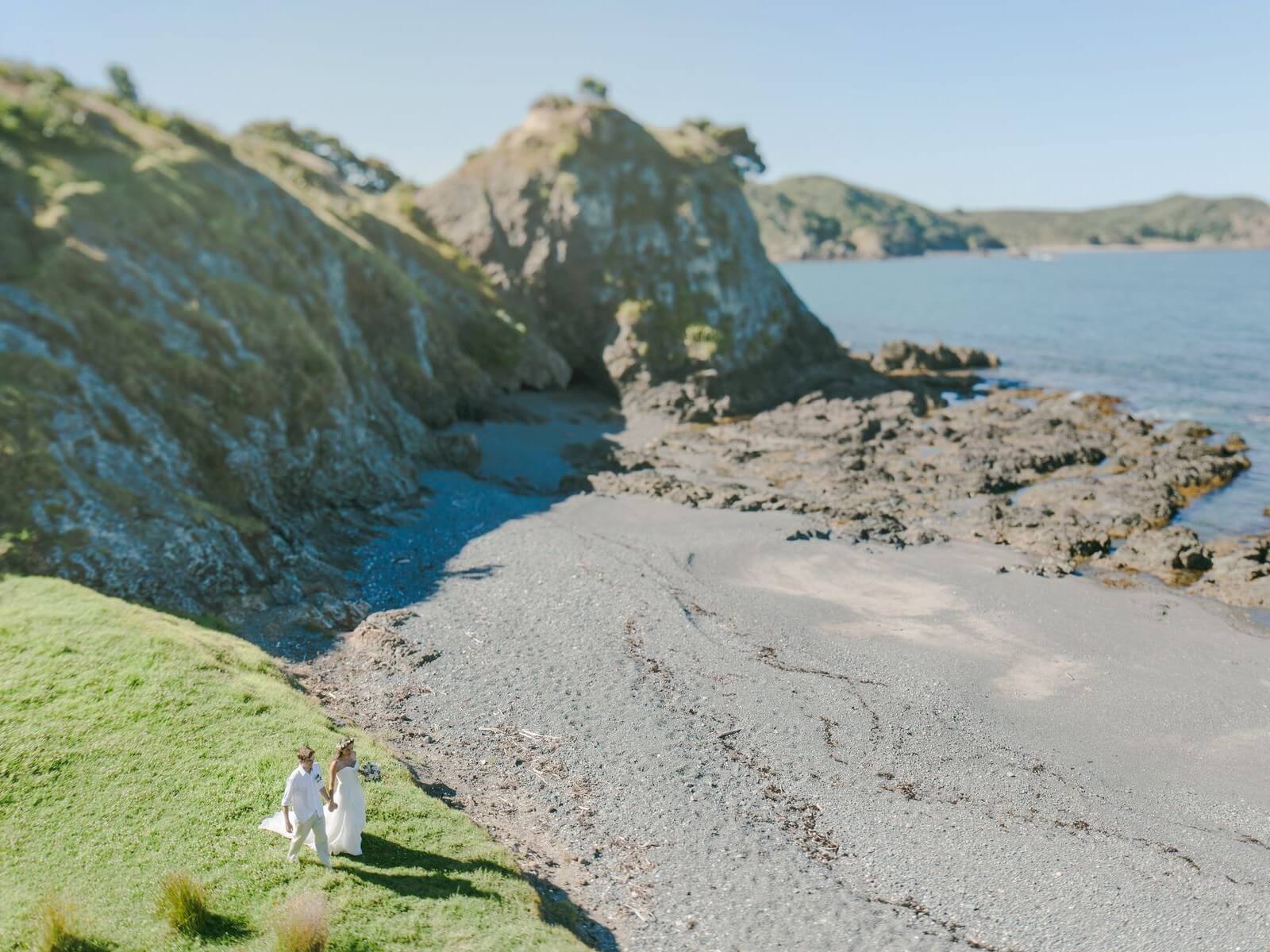 Newlyweds approaching beach