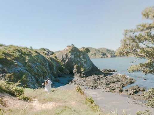 Newlyweds walk down to beach