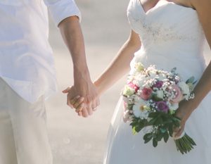 Newlyweds hold hands